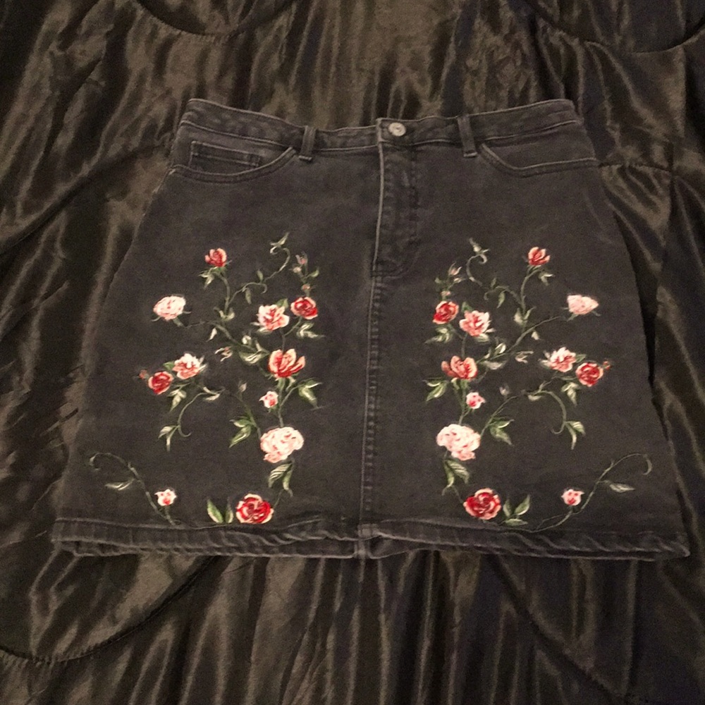 Black denim skirt with floral accent